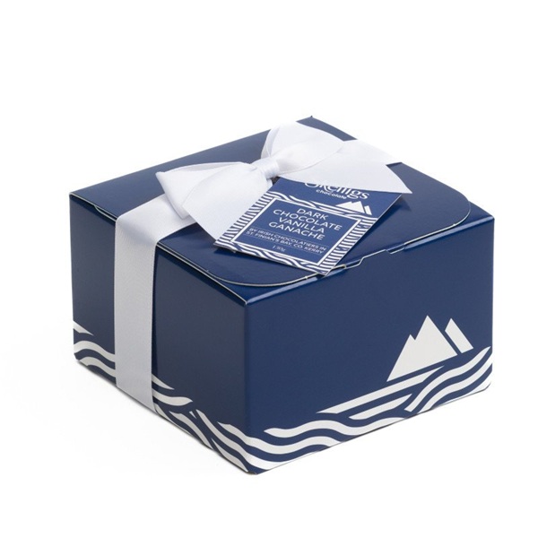 Skelligs Chocolate Vanilla Ganache Truffles in a navy and white box with a white bow tied around it.