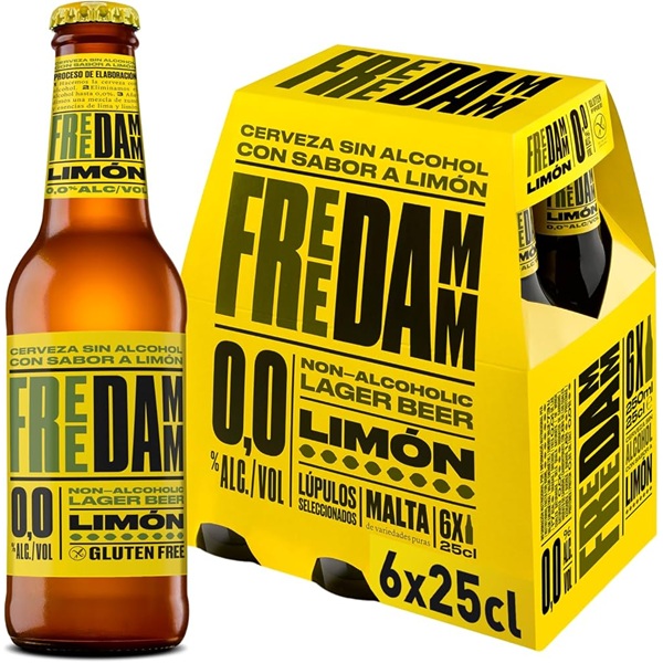 Free Damm 0.0 Non-Alcoholic Lemon Lager in a brown bottle with a yellow label and black text and a yellow card pack with black text beside it.